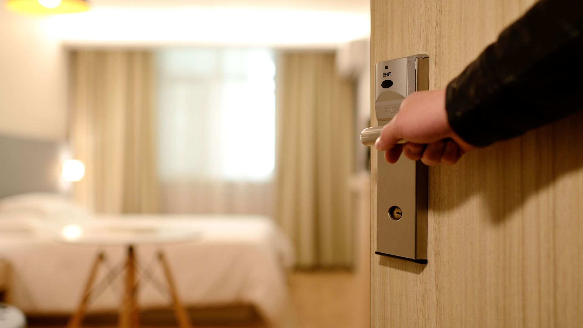 A soft-lit hotel room entrance, welcoming guests with luxury appeal and comfort.