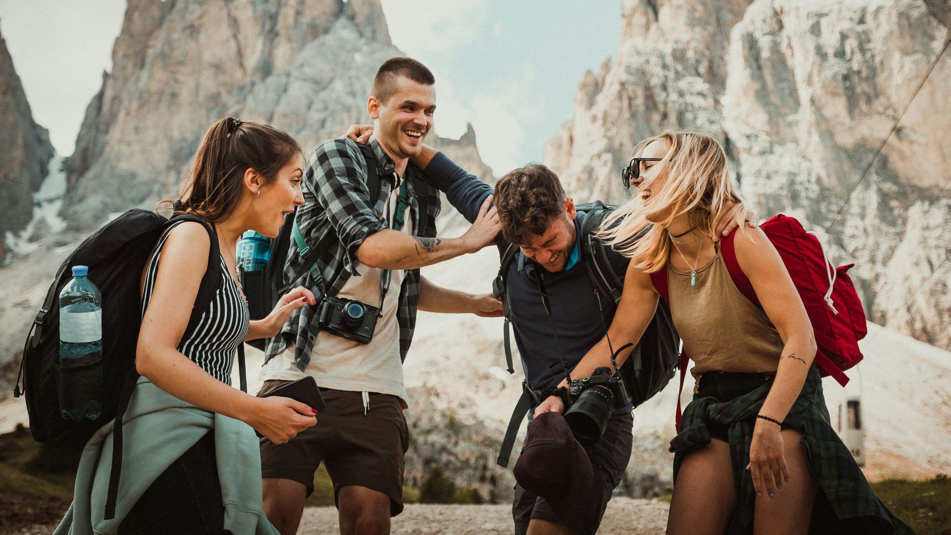 low-angle photography of two men playing beside two women