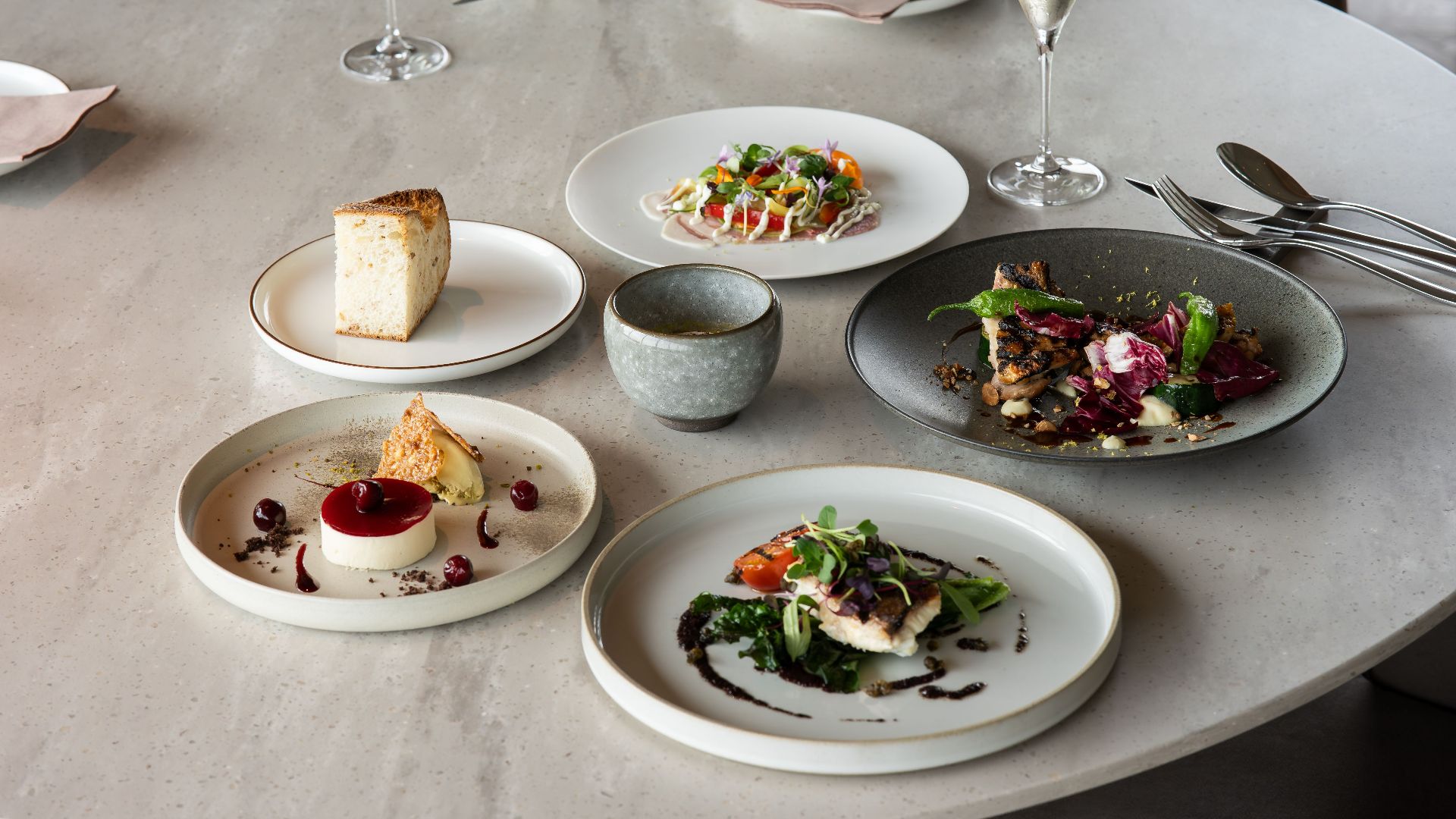 Elegant fine dining setup with gourmet dishes and wine in Tokyo, Japan.