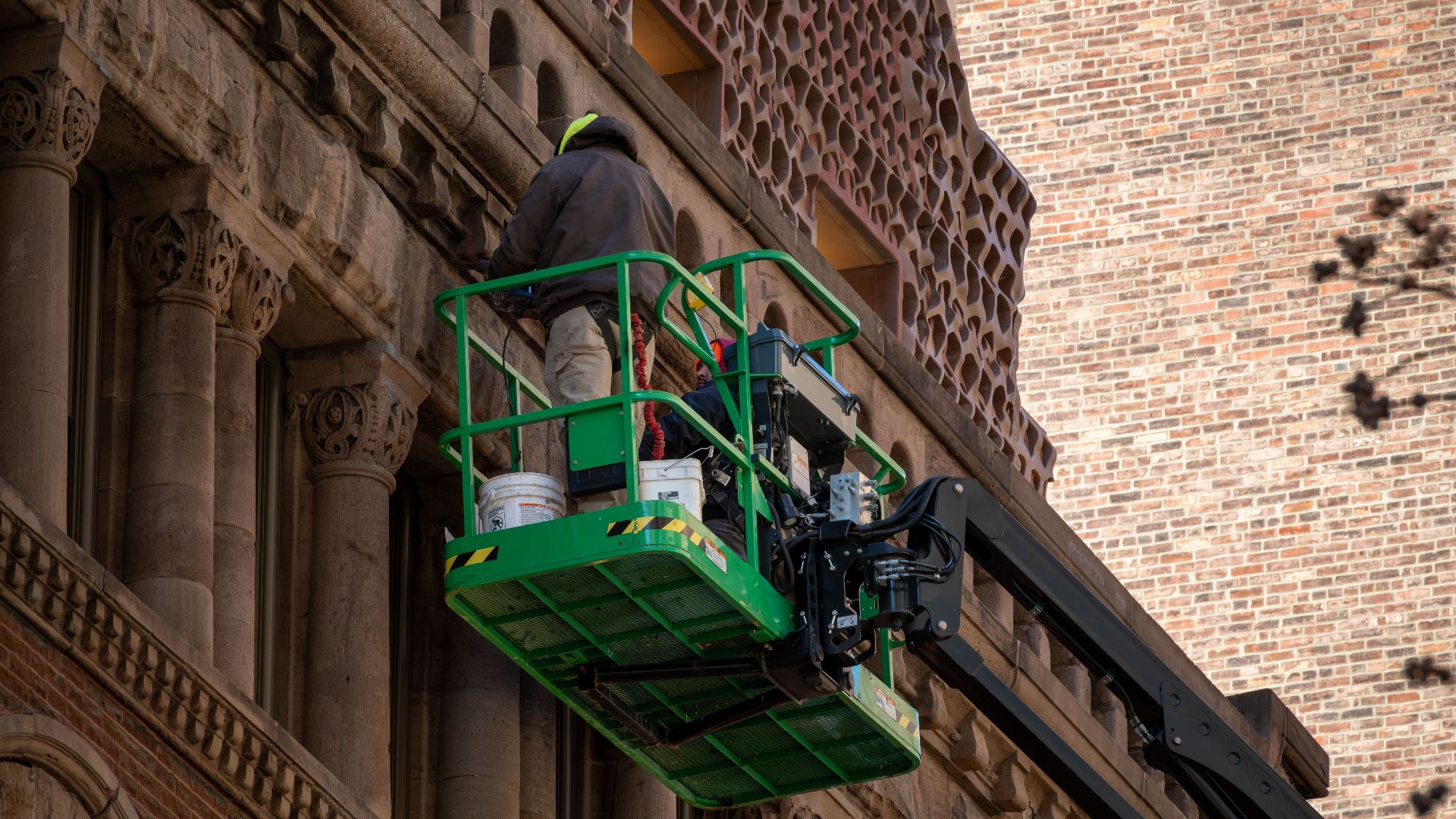 High-rise building restoration project using modern lift equipment.