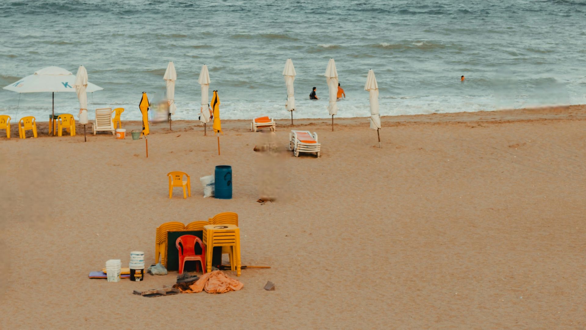 Empty beach with yellow chairs and umbrellas