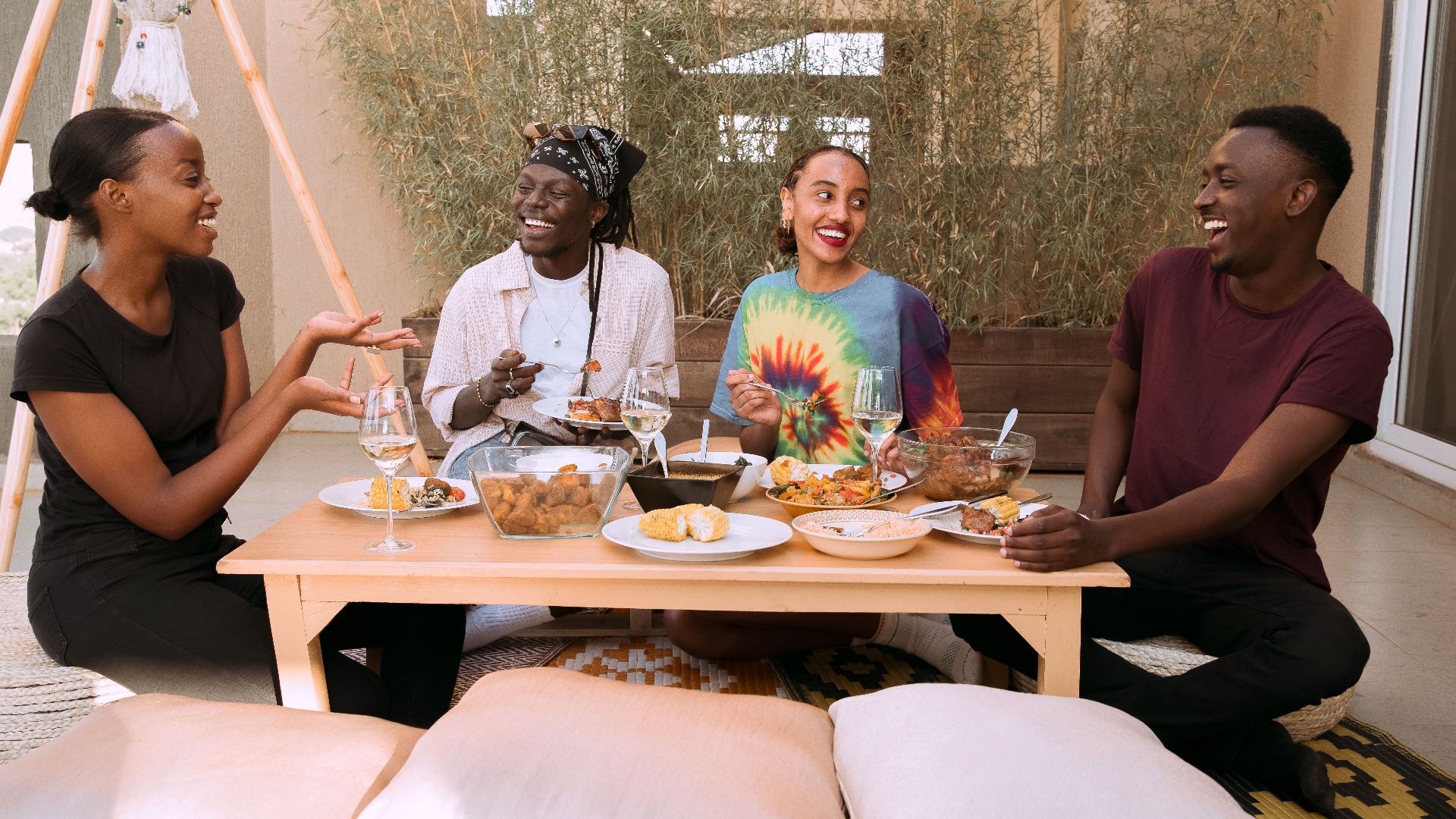 A cheerful group of friends bonding over a meal outdoors, enjoying conversation and laughter.