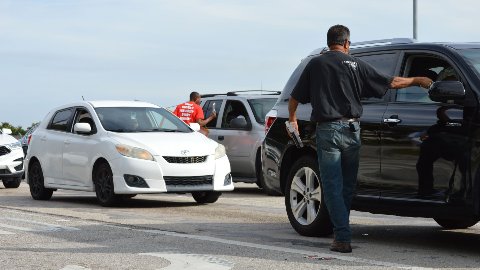 Traffic officer directing vehicles on a busy road intersection during daytime.