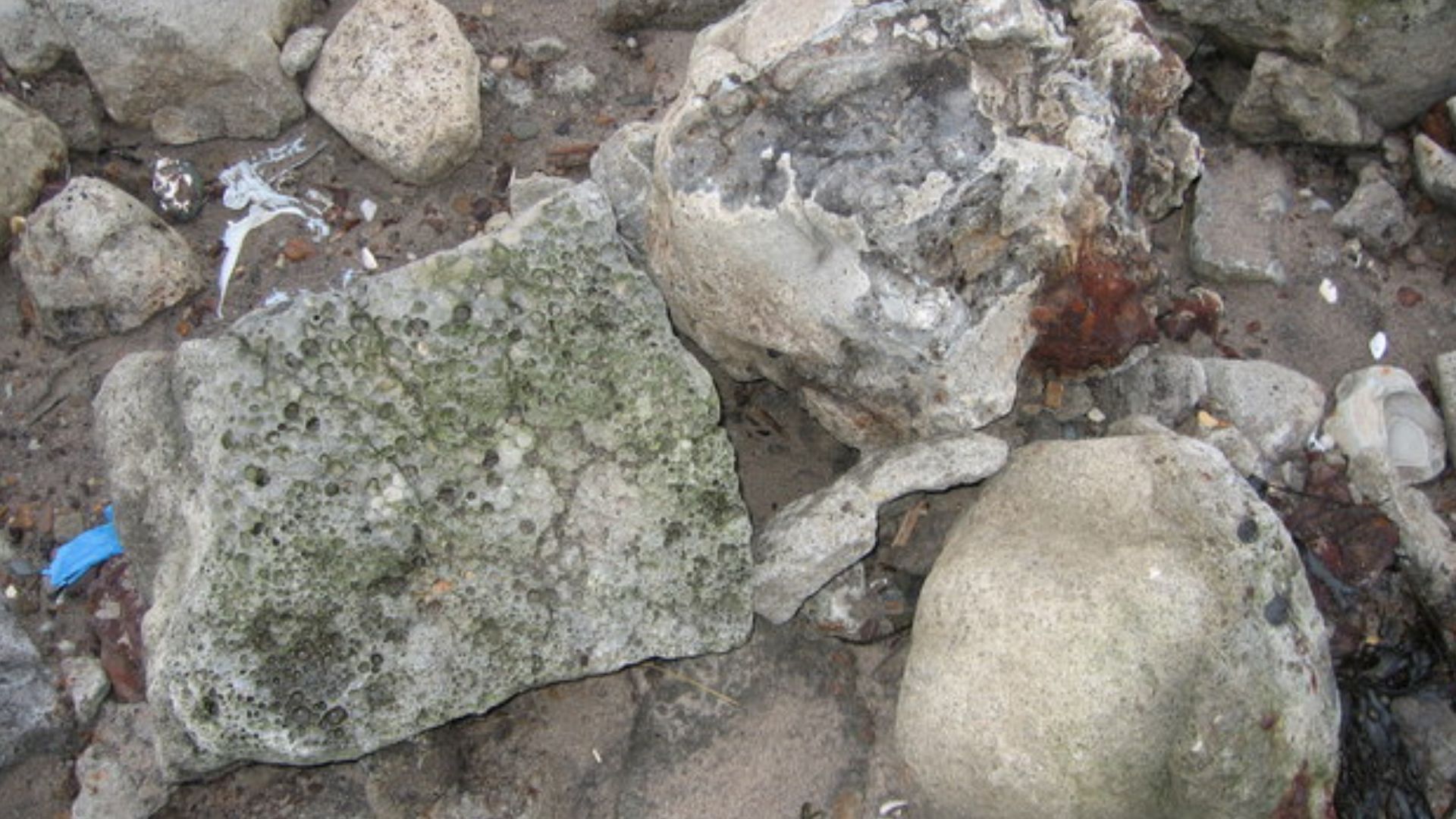 Slag There is a lot of slag on the beach here.I think it must have been used as sea defence. There must have been an Iron Works near by at one time! Some iron can still be seen in the slag.