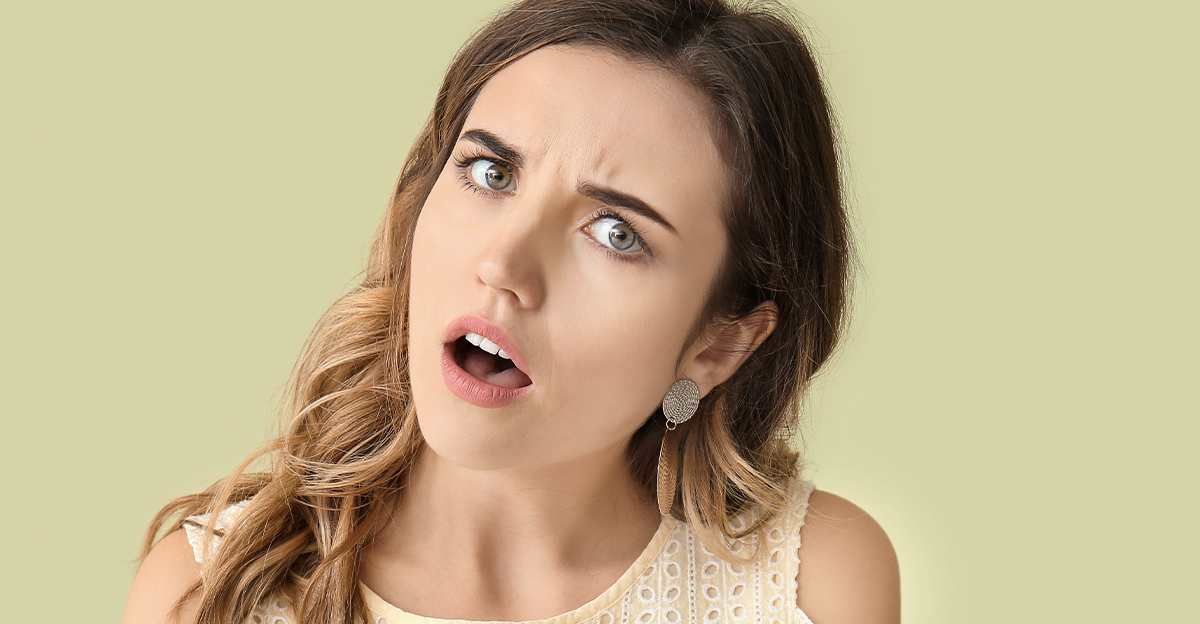 Shocked young woman, tilting her head.