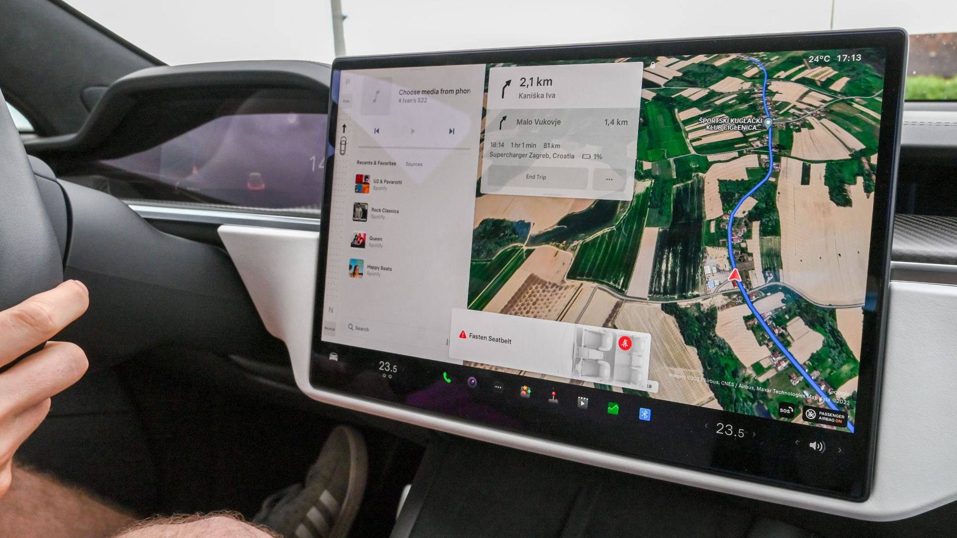 Inside view of a car with a large navigation screen and detailed digital map.
