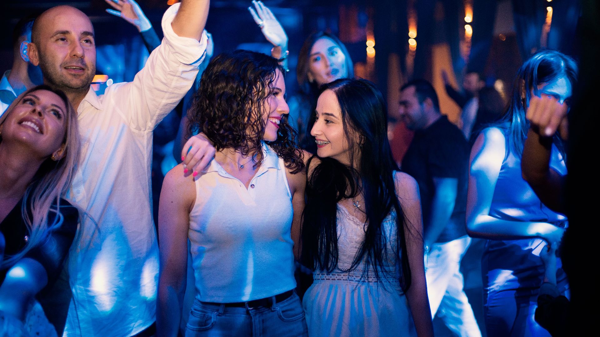 Young adults dancing and enjoying a lively night at a vibrant nightclub.
