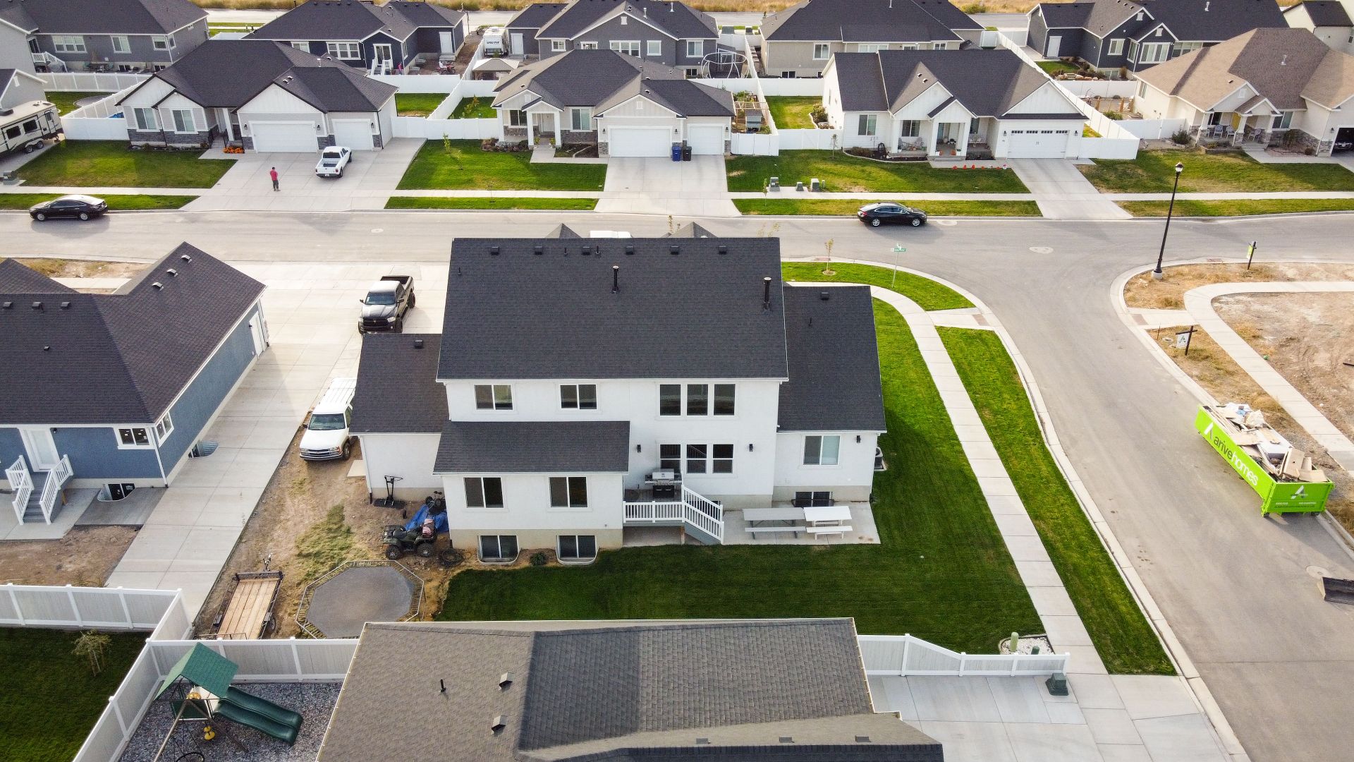 Aerial shot of a residential area in Spanish Fork, Utah, showcasing modern homes and green lawns.