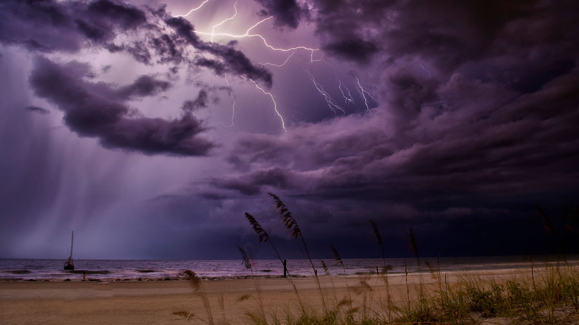 Dramatic lightning bolts illuminate the night sky over Redington Beach, creating a stunning natural scene.