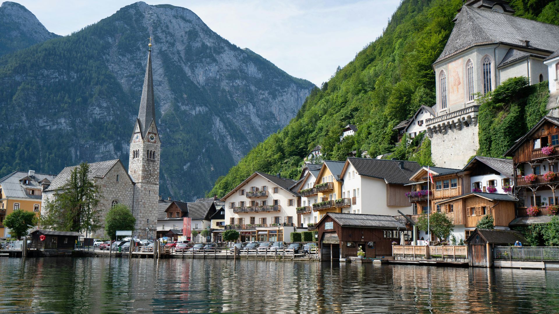 houses near body of water and mountain during daytime