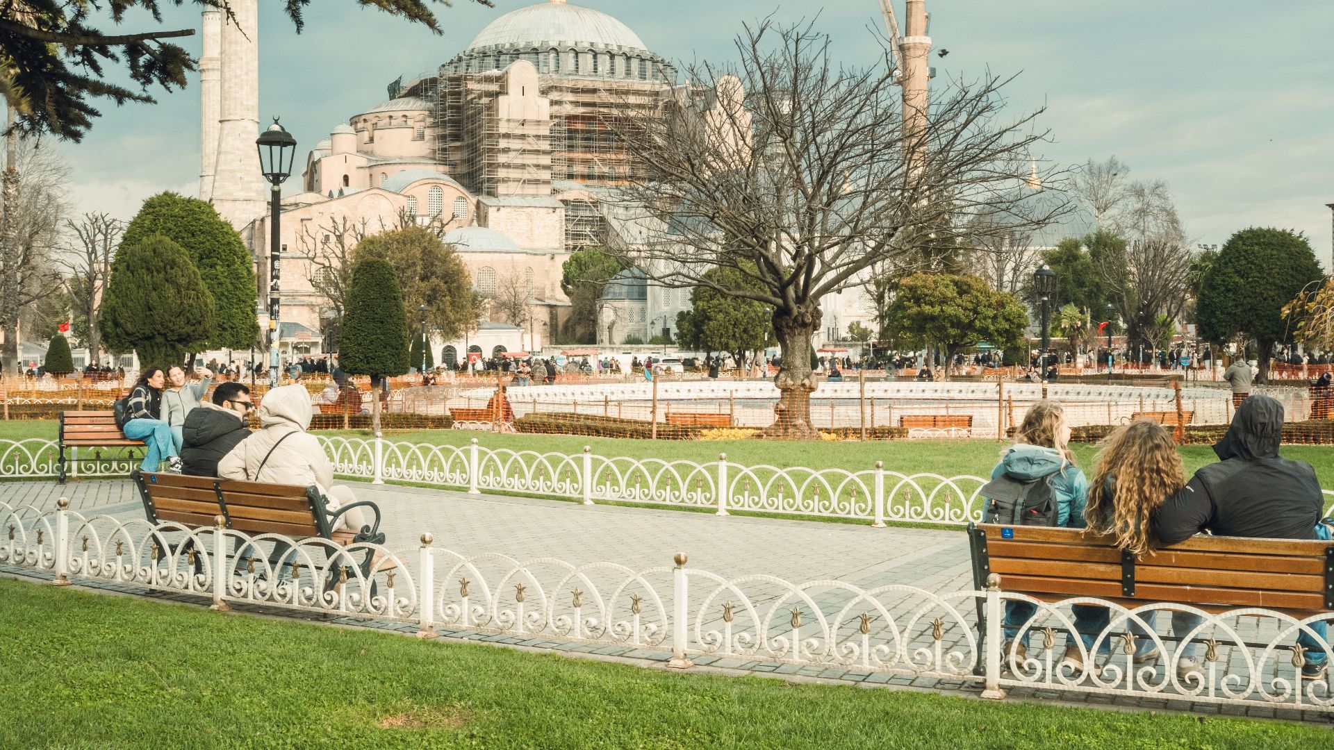 People enjoying a sunny day at a park near the iconic Hagia Sophia in Istanbul, Turkey.