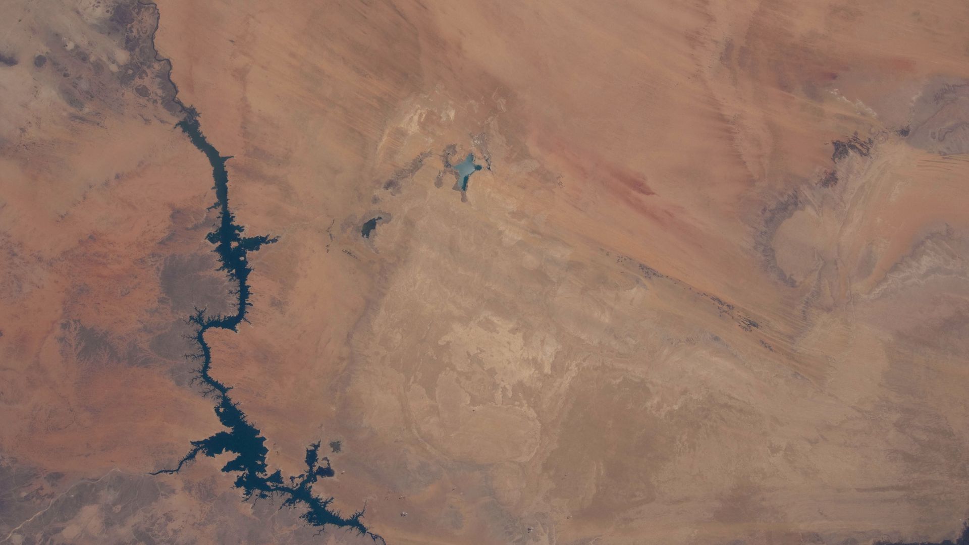 Toshka Lakes in southern Egypt are featured in this image photographed by an Expedition 31 crew member on the International Space Station.
The Toshka Lakes (center) were formed in the Sahara Desert of Egypt by water from the River Nile conveyed from Lake 