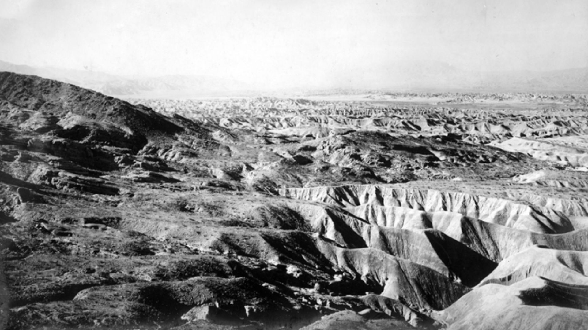 Old Miocene beach as seen from sandstone ridge at Garnet Canyon. Shows yellow shales cut into bad lands in upper valley creek. San Diego County, California. ca 1905.