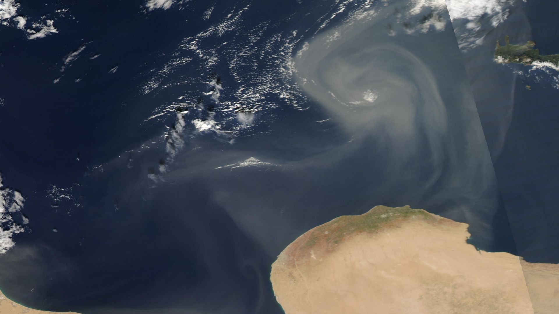 Gusting winds carried Saharan dust over the Mediterranean Sea in mid-November 2022.
On November 17, the Moderate Resolution Imaging Spectroradiometer (MODIS) on board NASA’s Terra satellite acquired a true-color image of the start of a dust storm, with ca