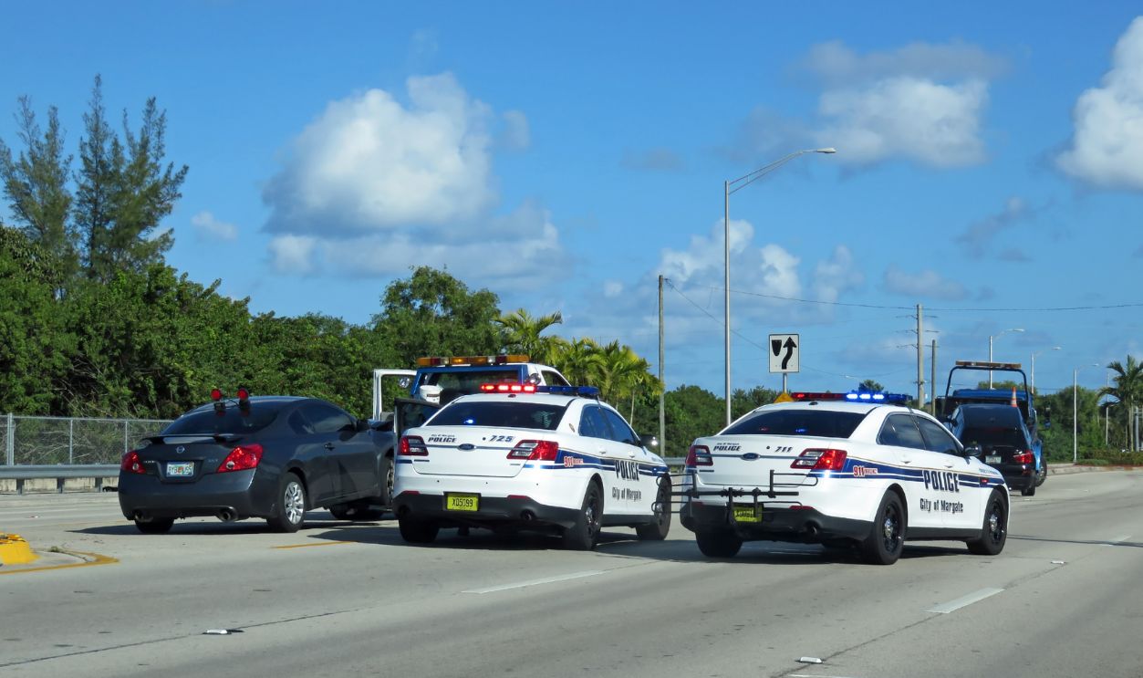 MARGATE, FLORIDA - FEBRUARY 08: Police Assisting Tow Truck on City Street Florida 2015
