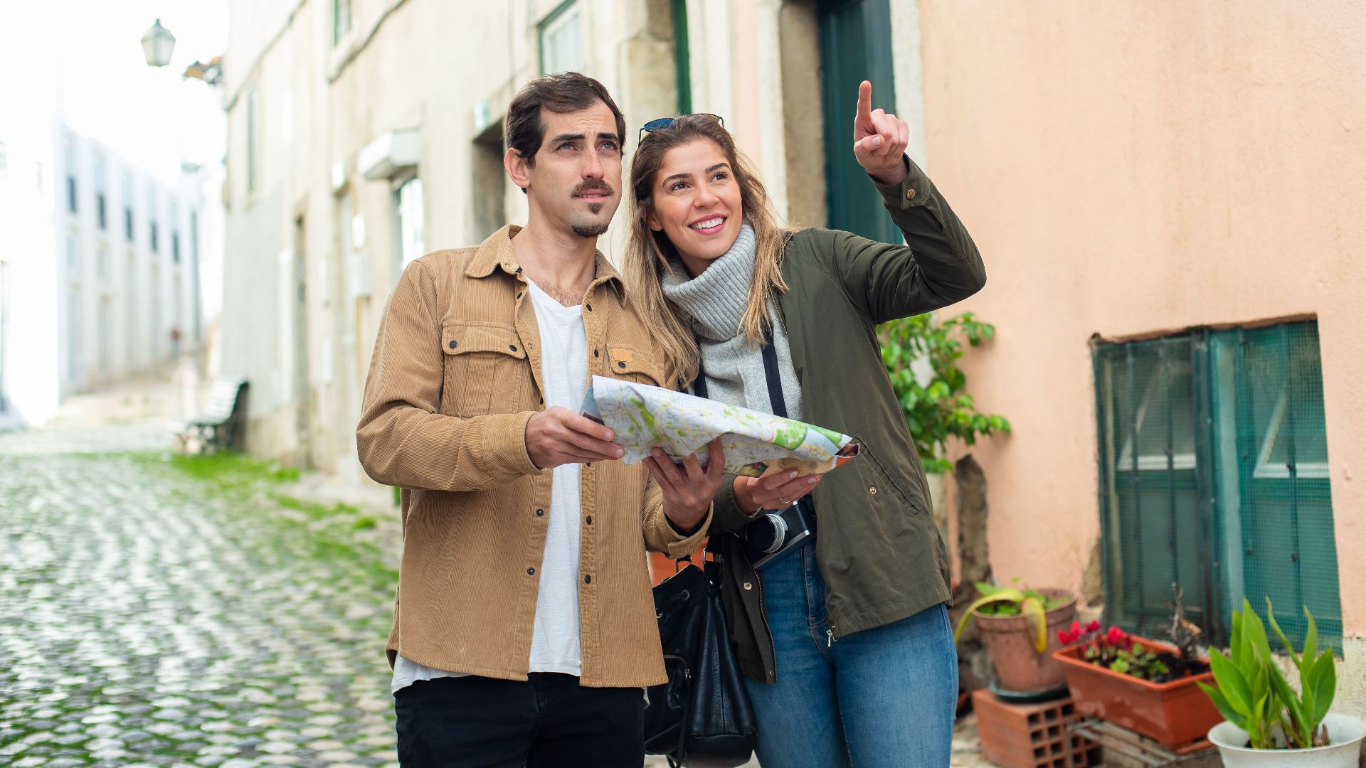 Happy couple exploring a charming European city street with a map. Perfect travel inspiration.