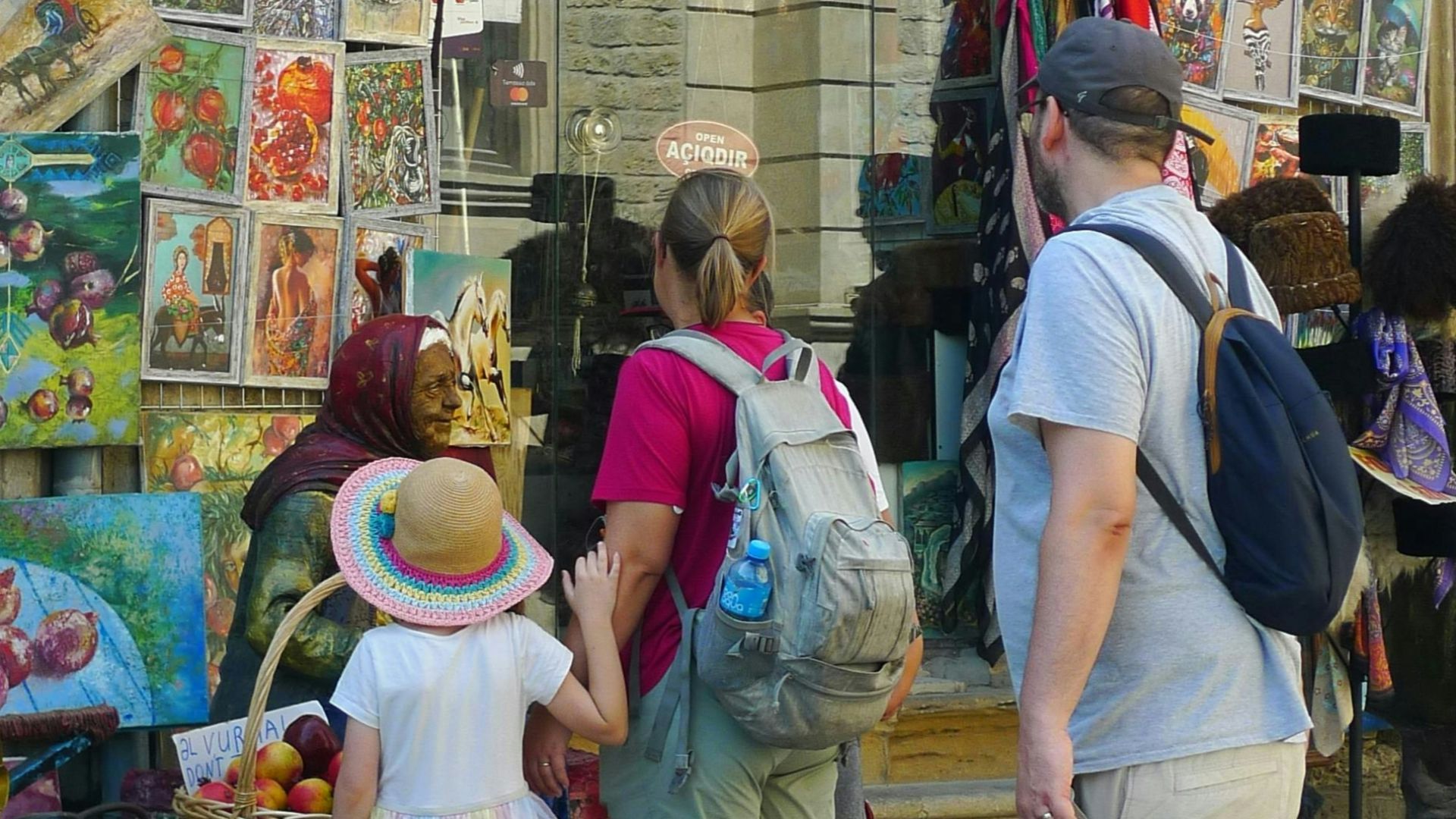 Family looking at souvenirs at an outdoor market stall