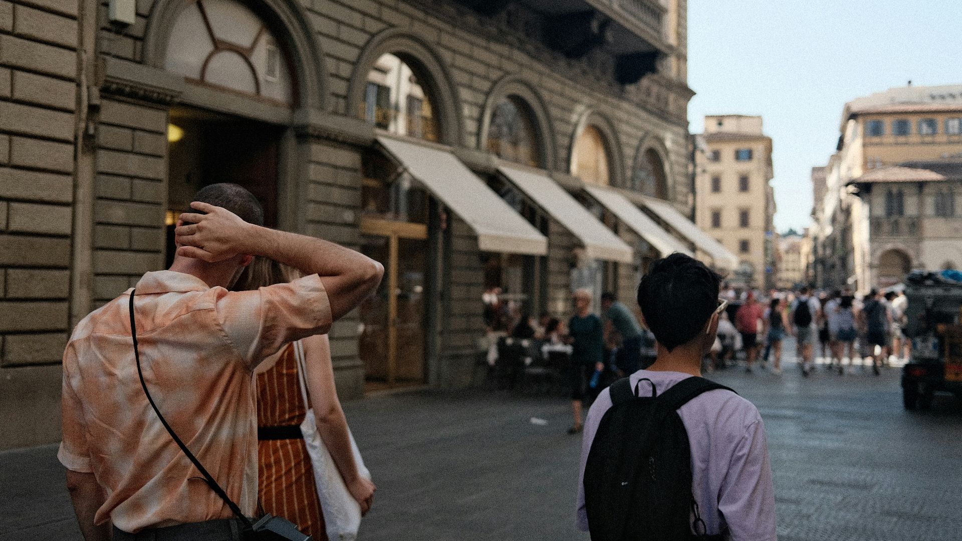 A couple of people that are walking down a street