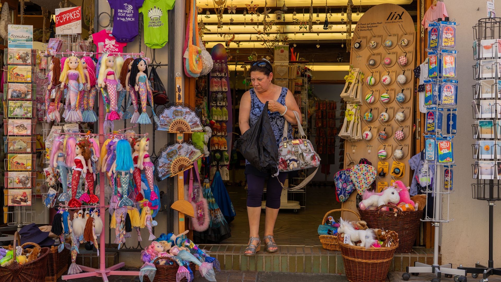 A cozy souvenir shop entrance filled with colorful toys, dolls, and unique gifts, inviting and vibrant.