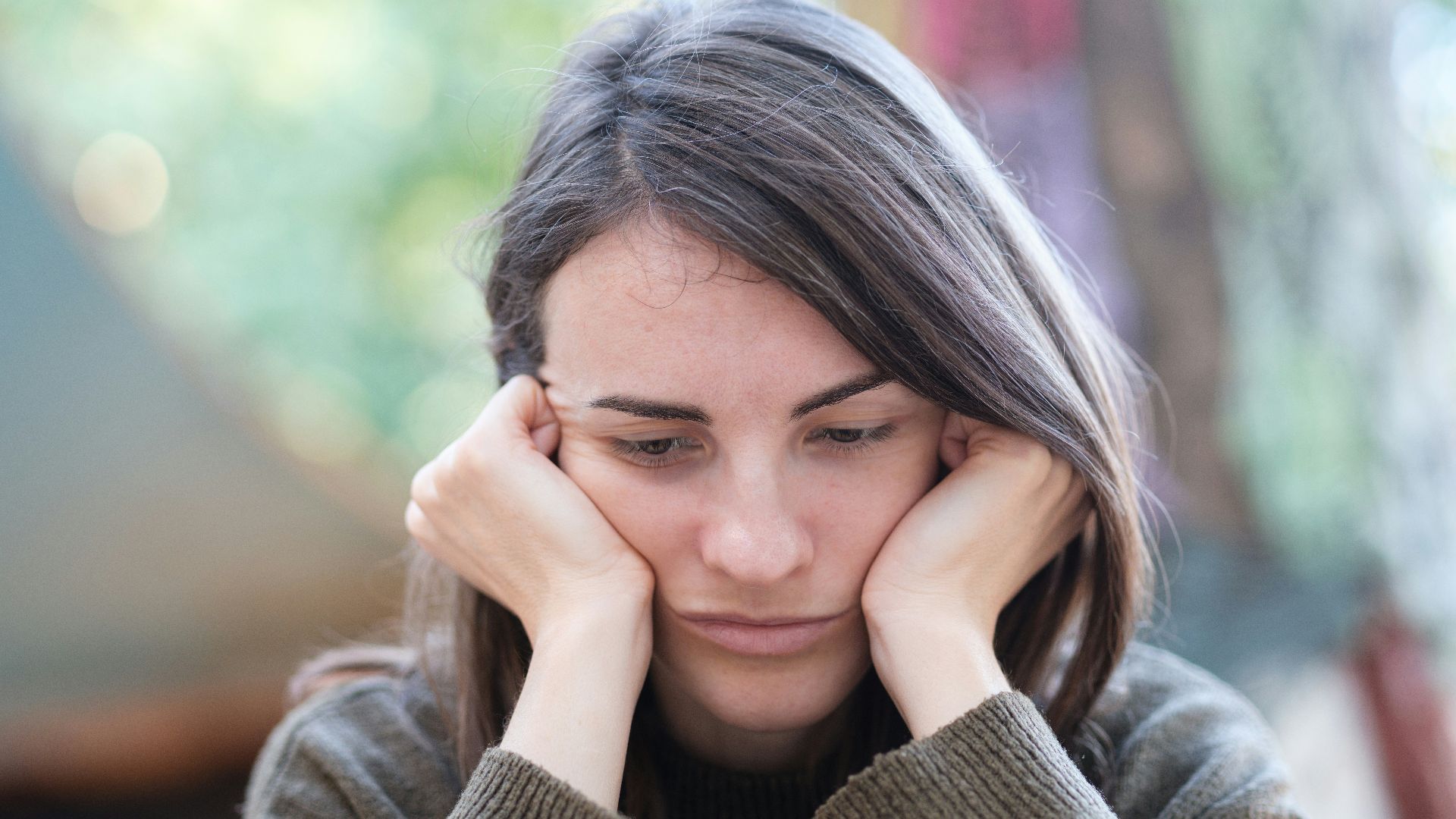 a woman holding her head in her hands