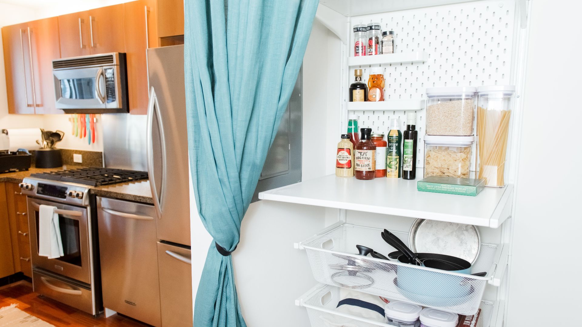 A contemporary kitchen featuring stainless steel appliances and a well-organized pantry.