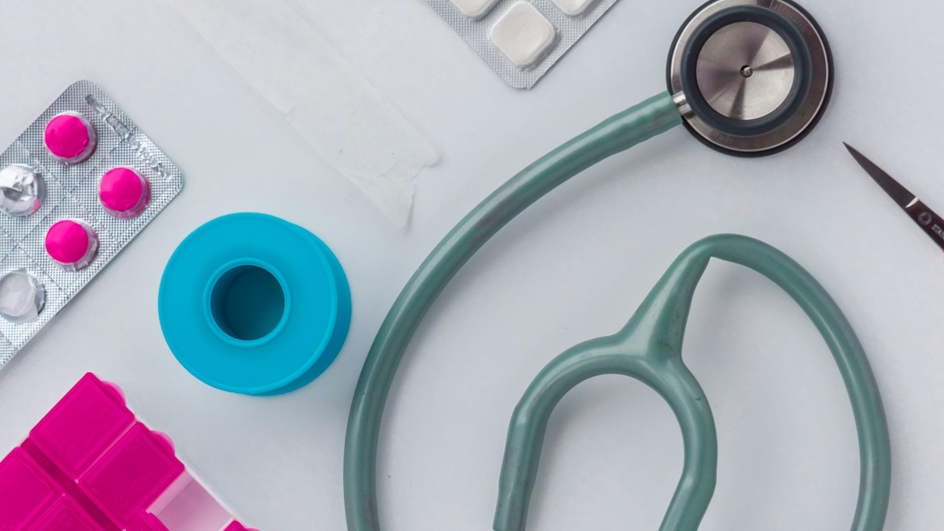 green and silver stethoscope on white envelope