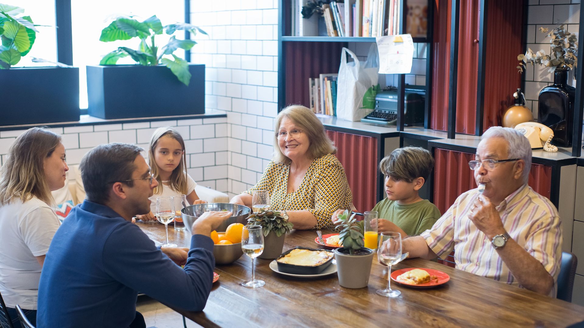 A joyful family dining together indoors, highlighting togetherness and culinary enjoyment.