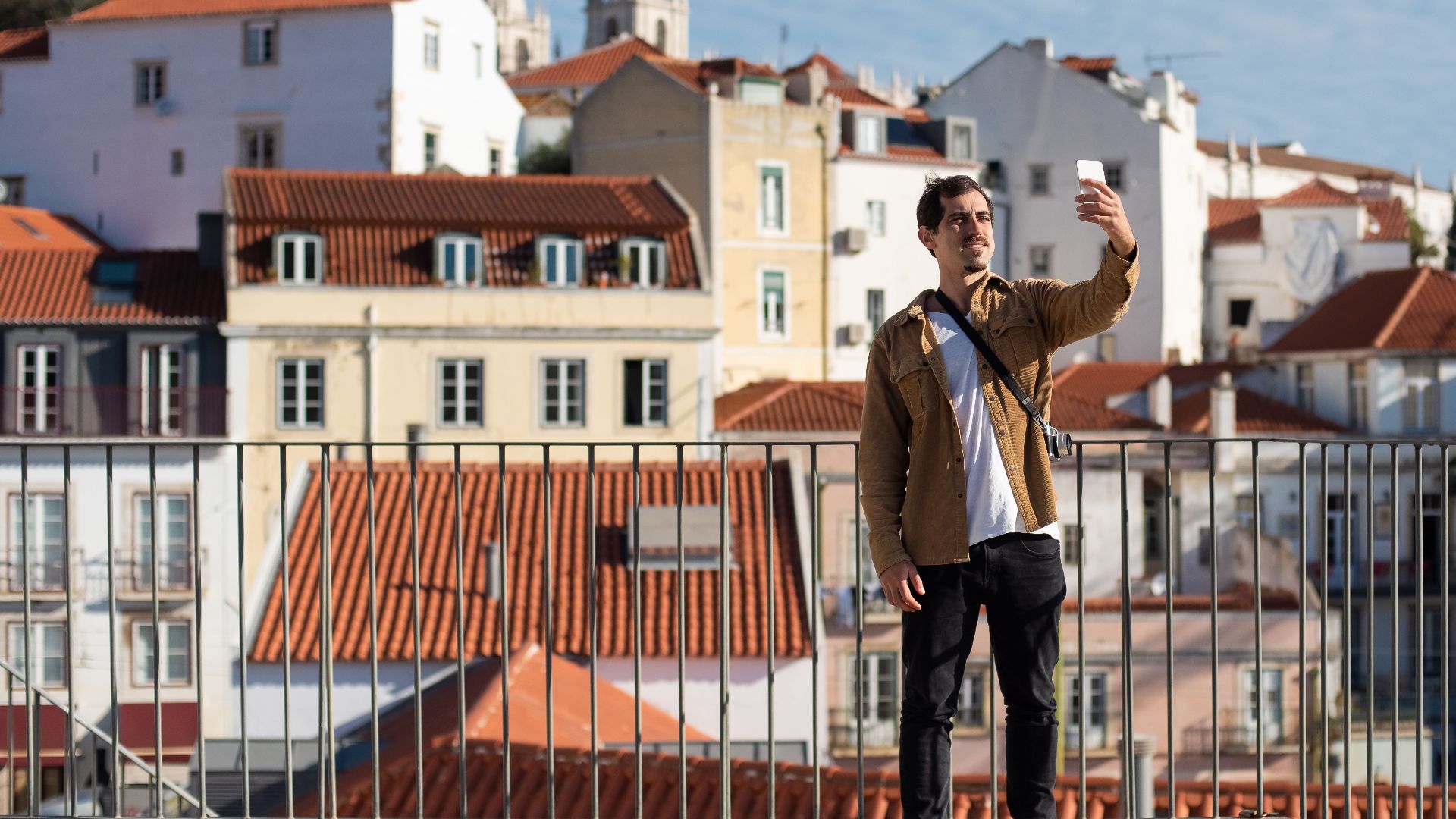 Casual traveler capturing a selfie amidst Lisbon's iconic architecture.