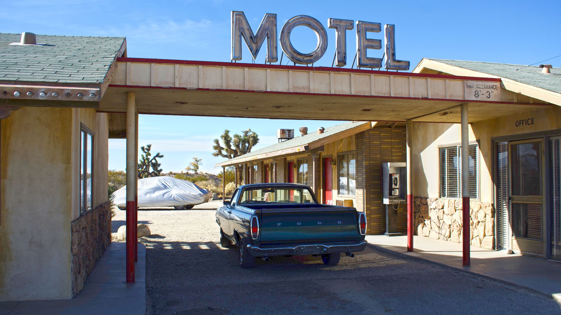 Retro motel scene in Lancaster, California featuring parked vintage pickup truck.