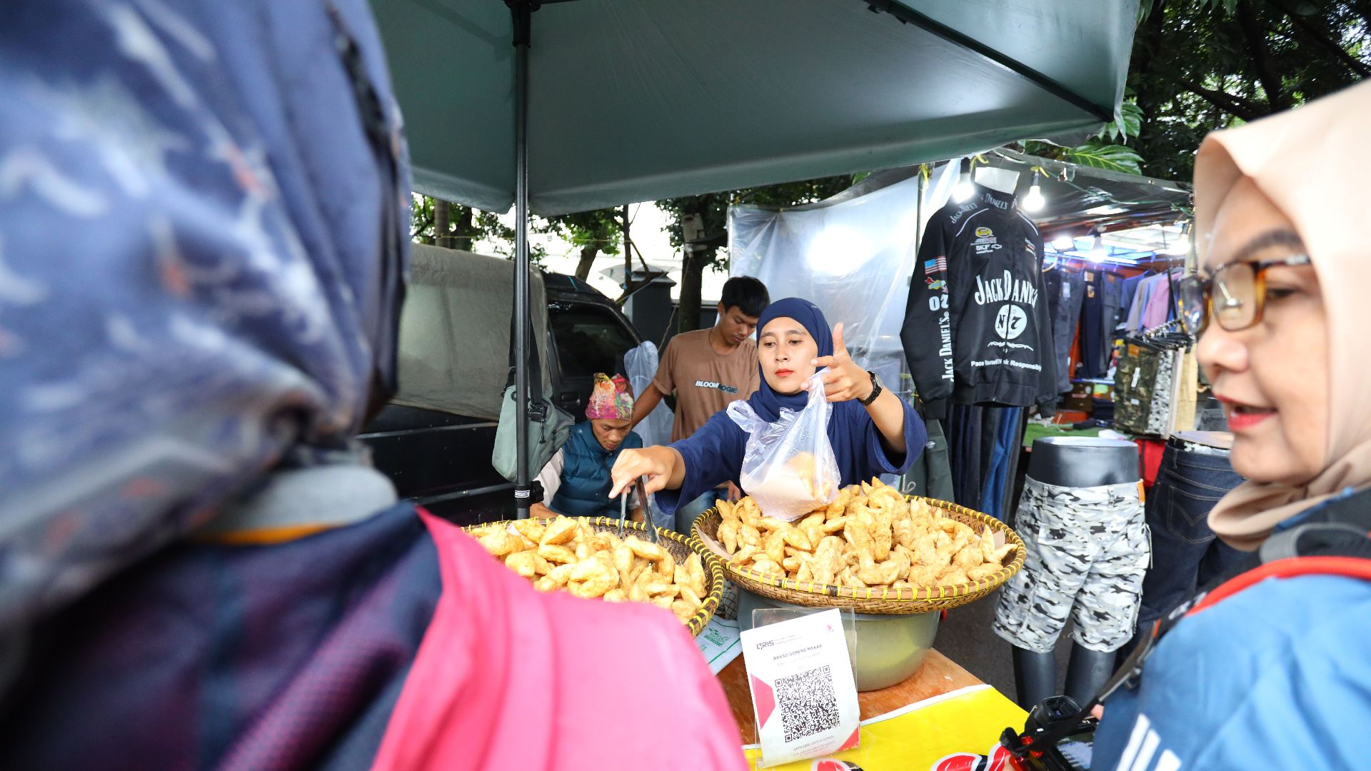 Vibrant street market scene in Jawa Barat with vendor selling local snacks.
