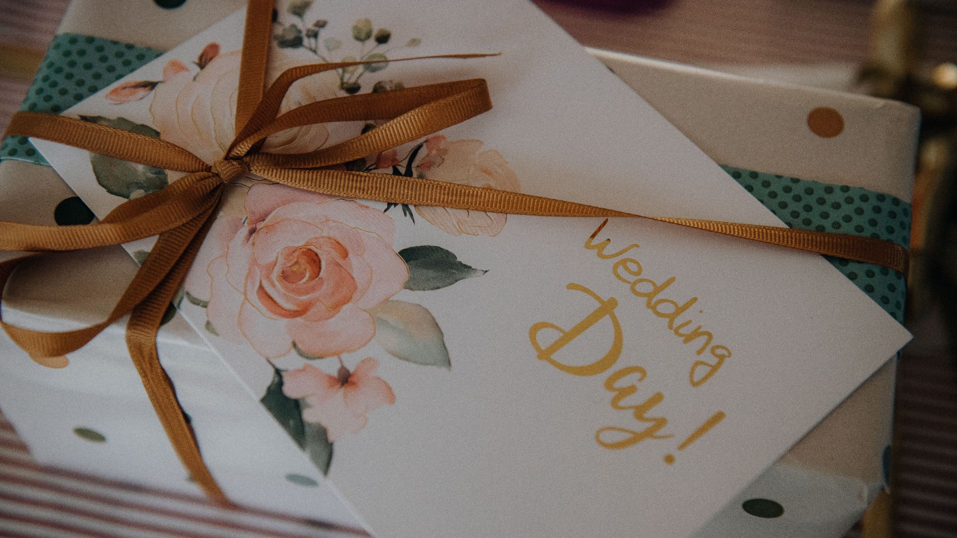 Beautifully wrapped wedding present with floral card and ribbon, perfect for celebrating a special day.