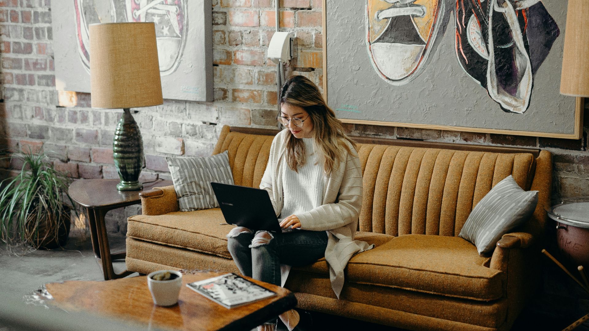 woman using laptop while sitting on chair