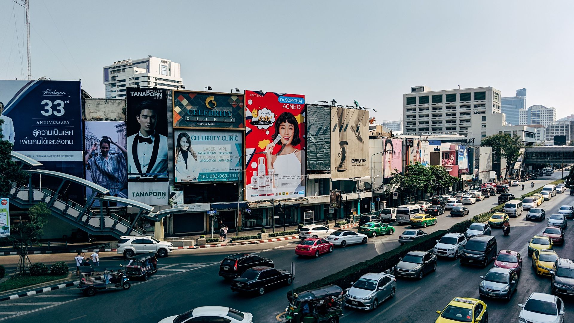 Dynamic cityscape of Bangkok showcasing heavy traffic and colorful billboards in the metropolis.