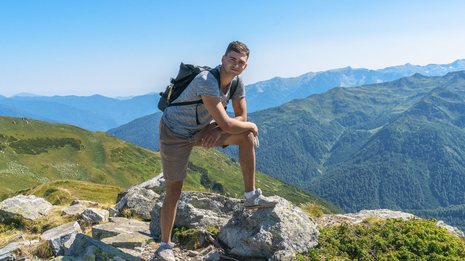 Man enjoying scenic mountain view during a summer hike in Гагра. Perfect for travel and adventure themes.