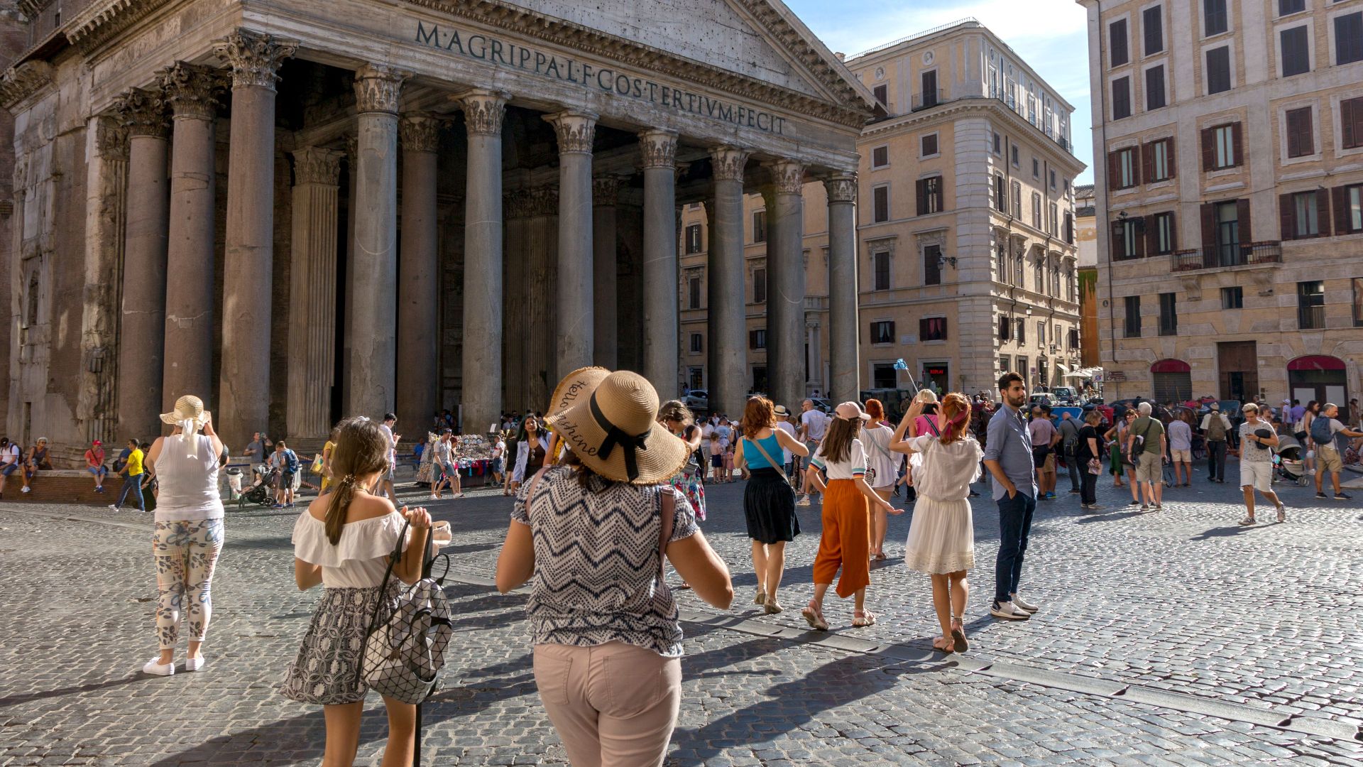 A vibrant scene of tourists visiting the iconic Pantheon in Rome, Italy, on a sunny day.