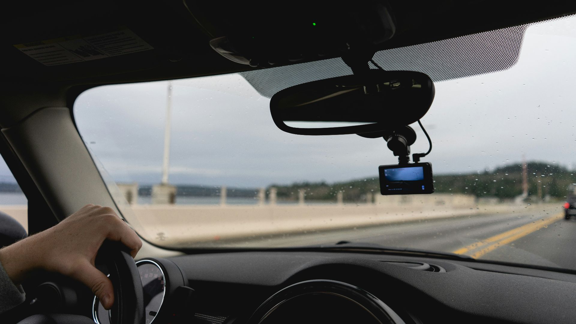 a person driving a car on a highway