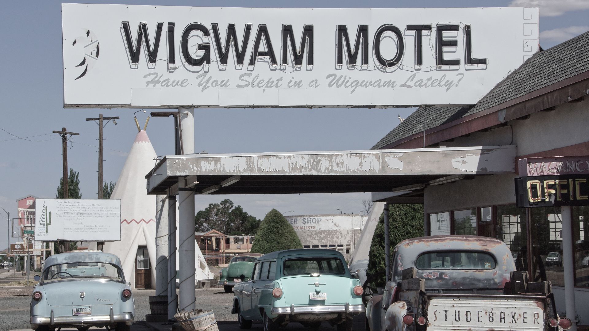 A nostalgic view of classic cars parked at the iconic Wigwam Motel in Holbrook, Arizona.