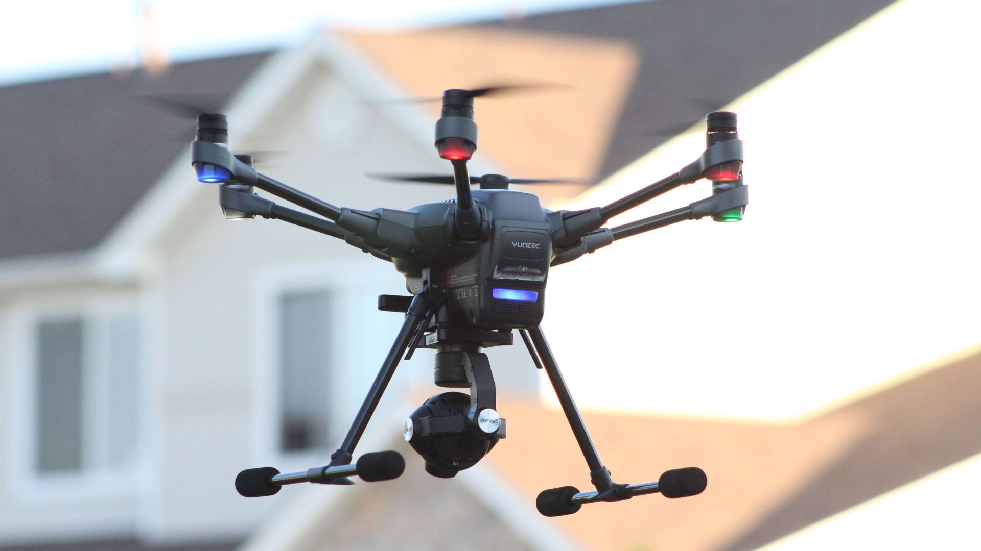 A drone flying in a suburban area, capturing aerial views of a residential neighborhood.