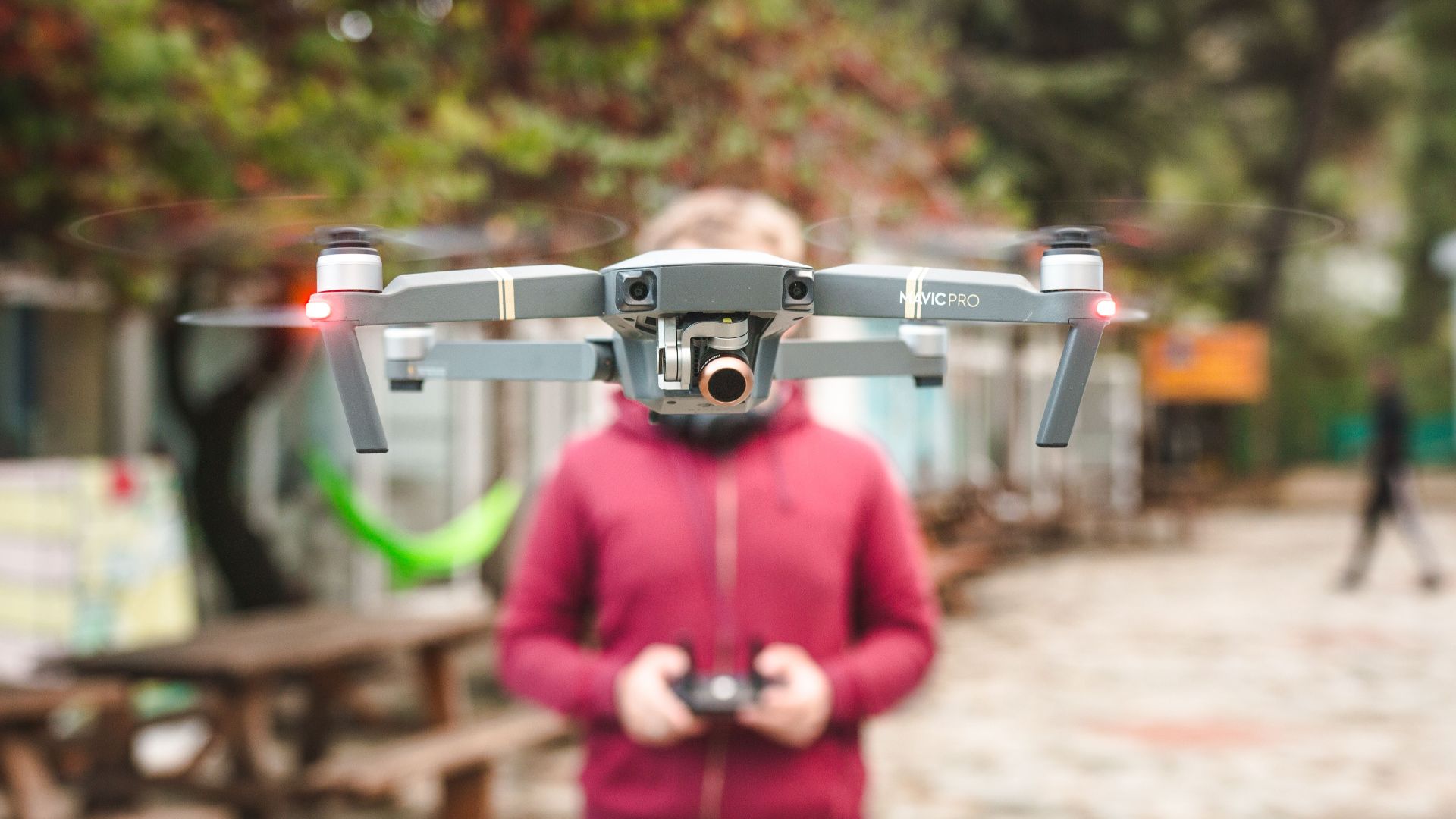 A DJI Mavic Pro drone hovers outdoors with a person controlling it in Limassol, Cyprus.