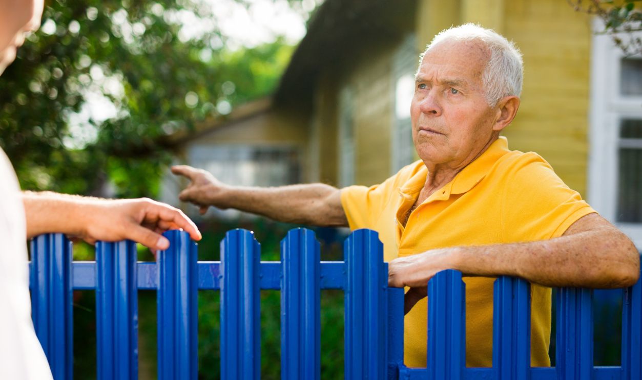 Good neighbors talk on border of their
