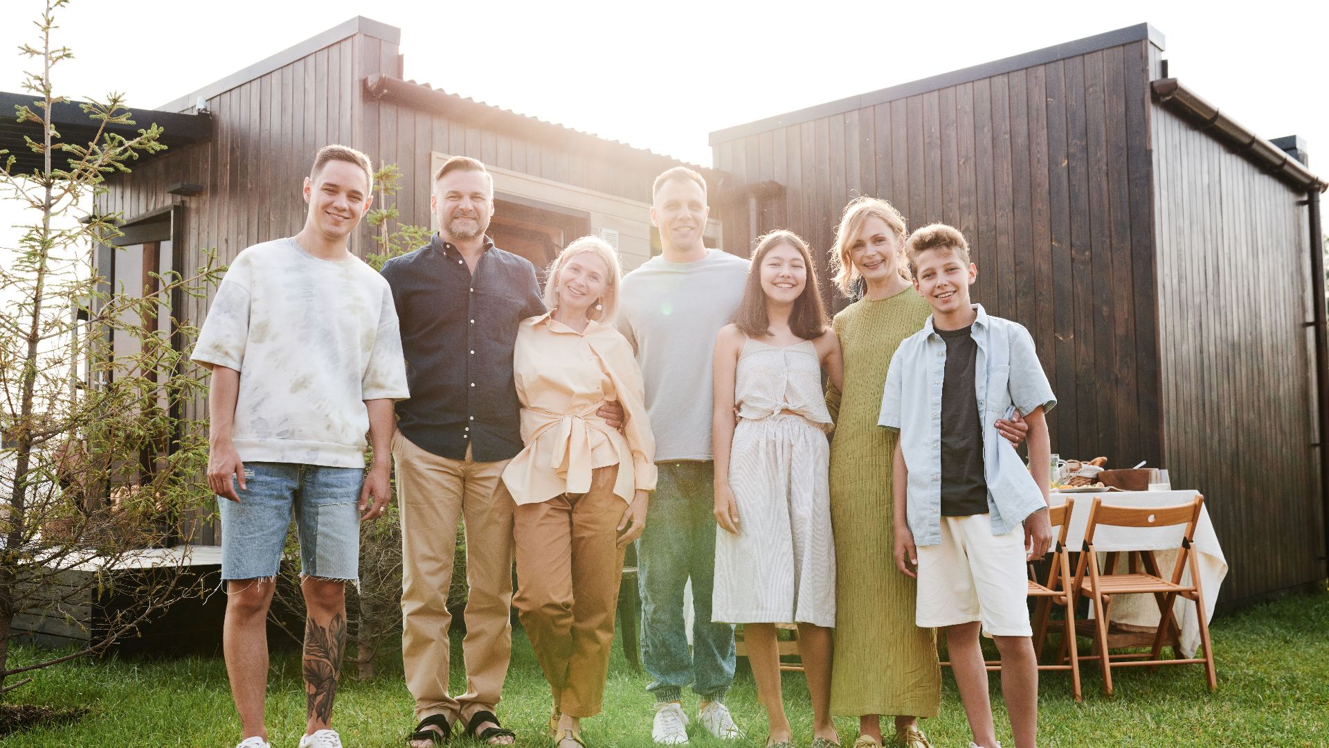 A joyful family posing together in a sunny outdoor setting, enjoying quality time.