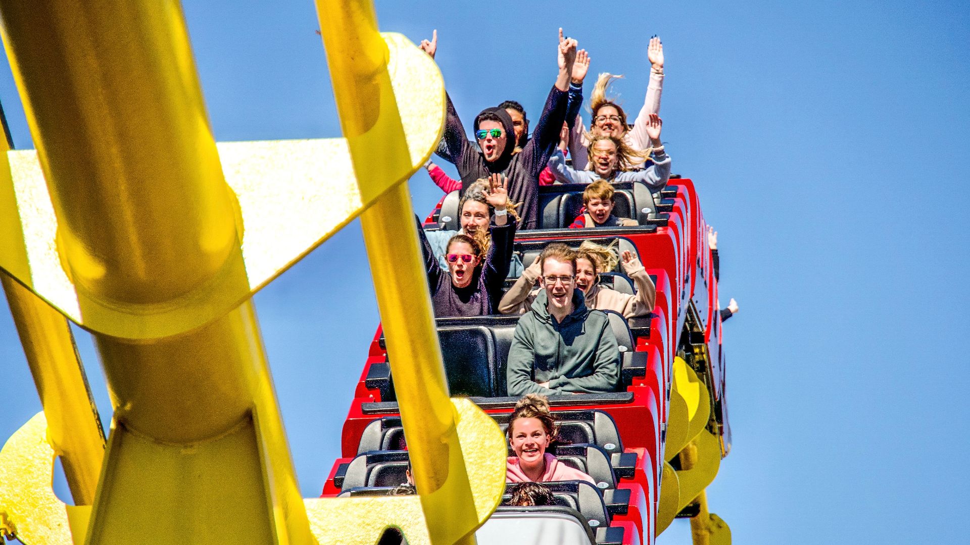 Thrilling roller coaster ride capturing the joy and excitement of passengers in Santa Monica.
