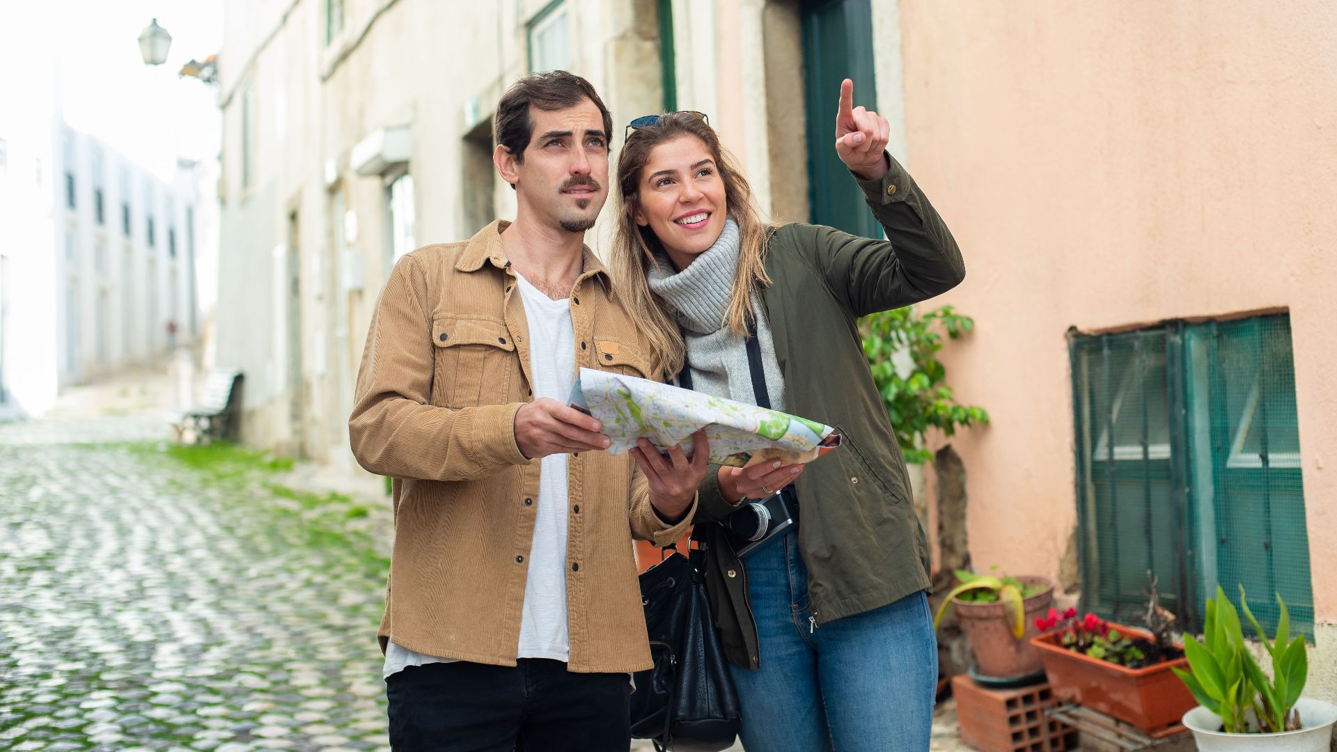Happy couple exploring a charming European city street with a map. Perfect travel inspiration.