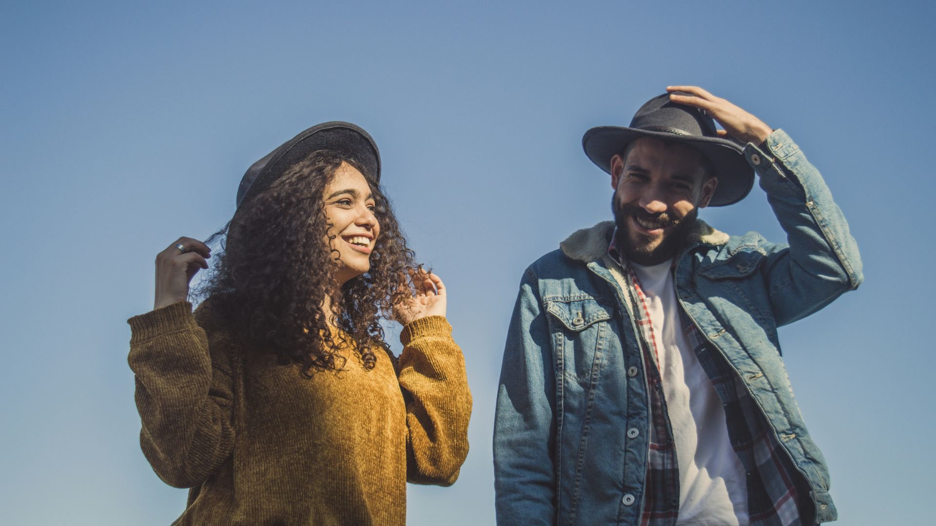 man and woman standing under blue sky