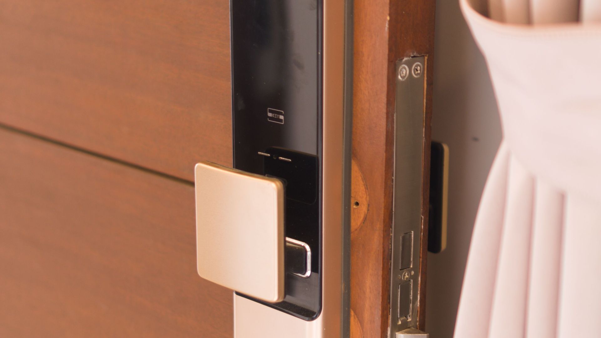Close-up of a smart door lock system, offering enhanced security on a wooden door.