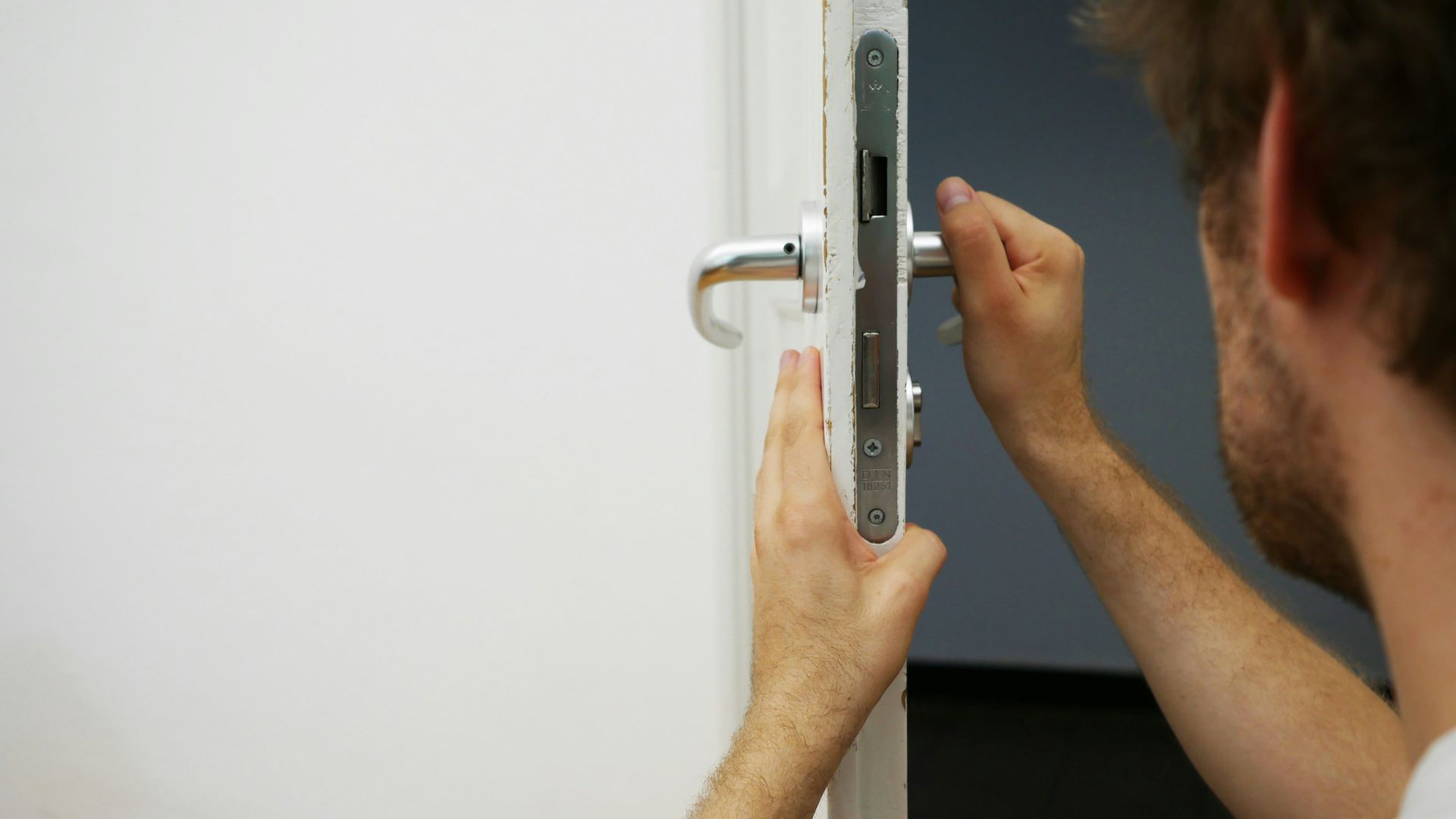 person holds door lever