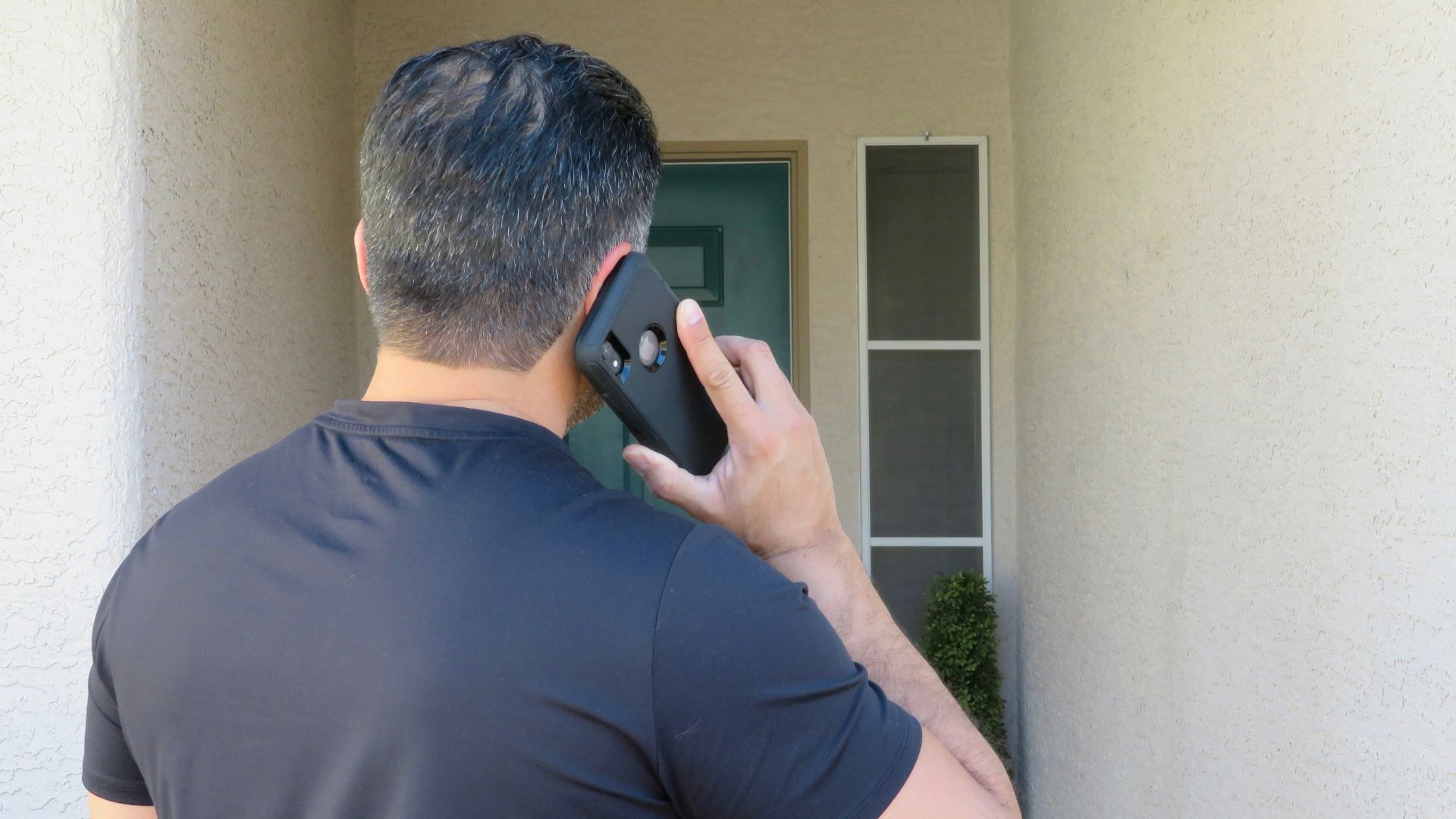 a man holding a cell phone up to his ear