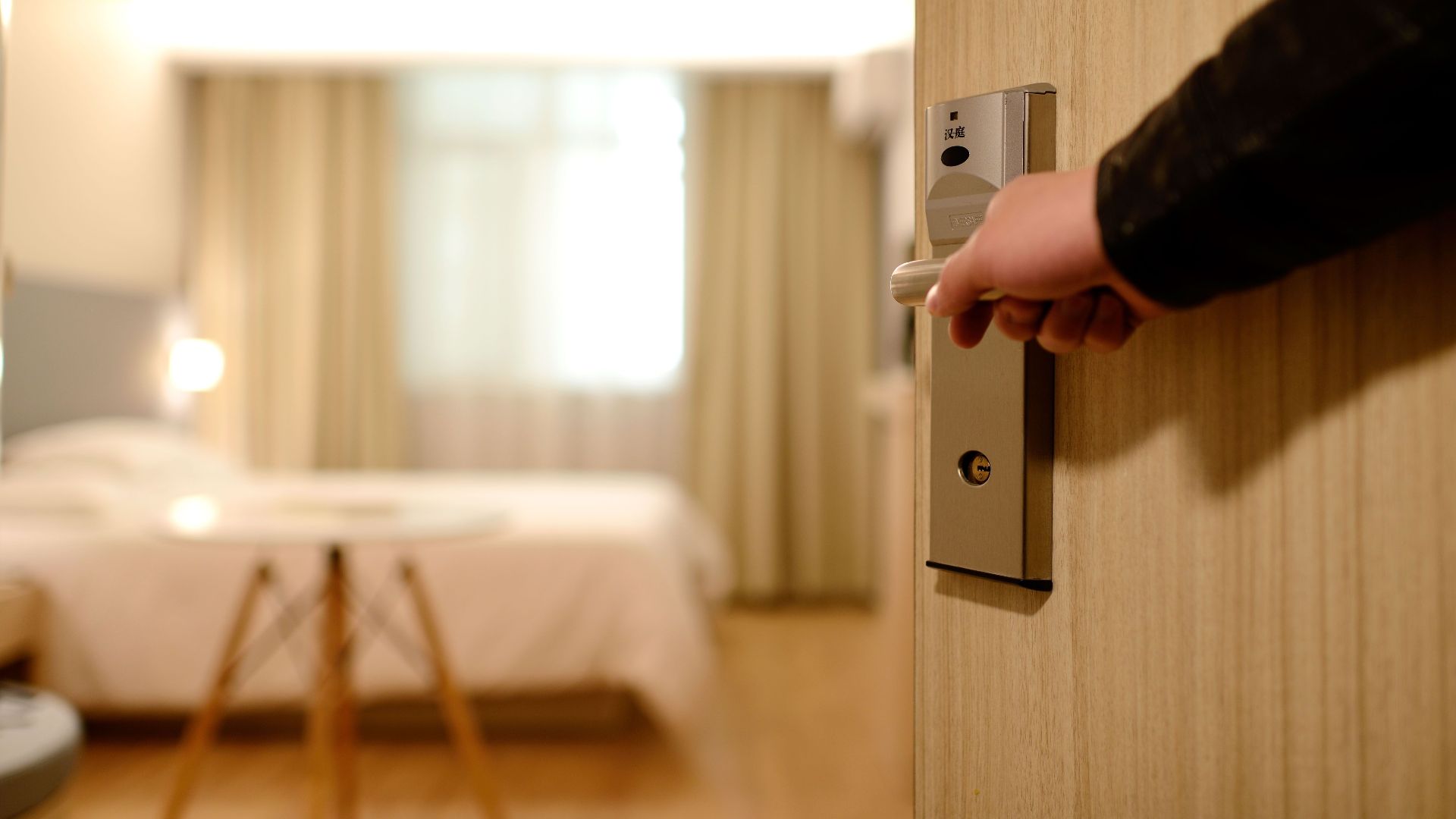 A soft-lit hotel room entrance, welcoming guests with luxury appeal and comfort.