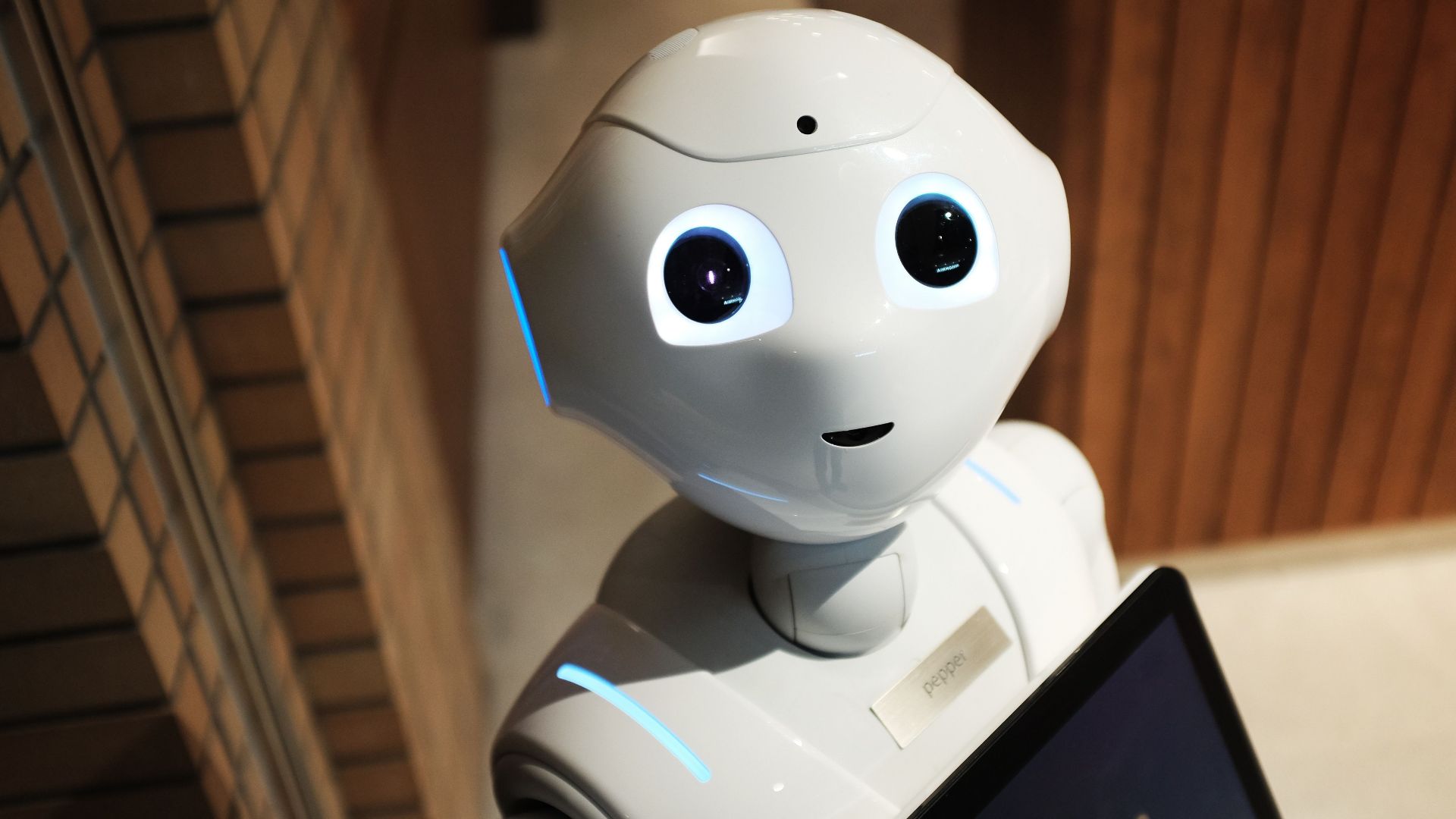A futuristic humanoid robot in an indoor Tokyo setting, showcasing modern technology.
