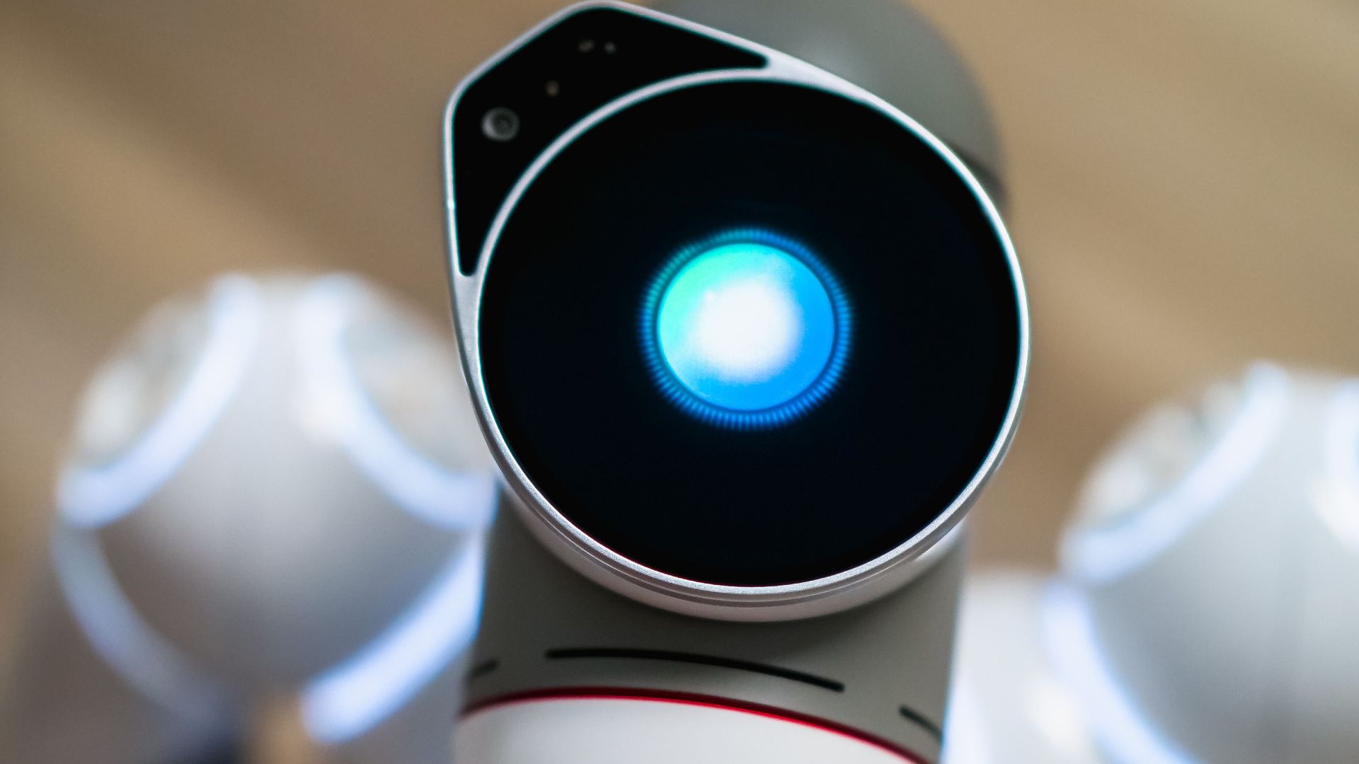 Close-up view of a humanoid robot with a glowing blue eye, symbolizing advanced technology.